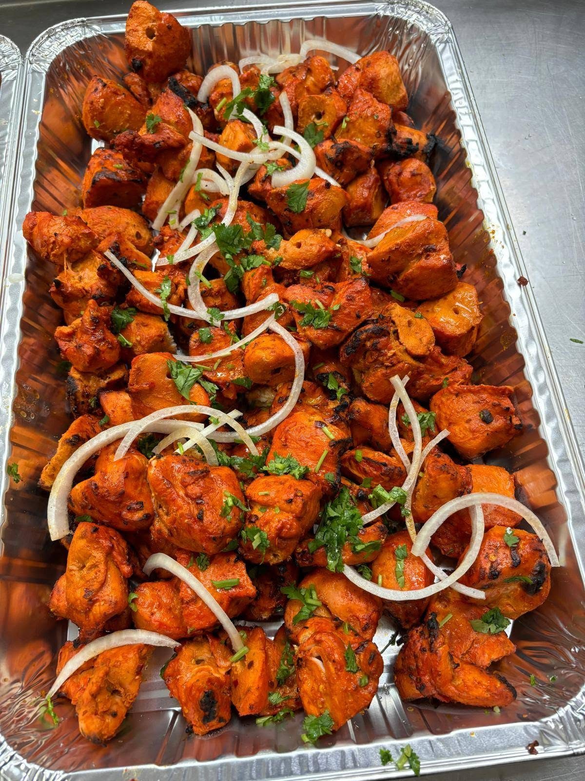 Chicken tikka packed in a catering tray